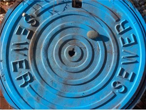 blue sewer manhole cover