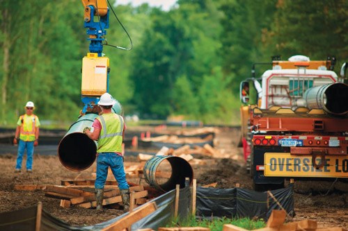 A Vacuworx vacuum lifting system is used to move steel pipe into place on the pipeline project.