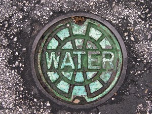 sewer manhole cover with "water" written on it