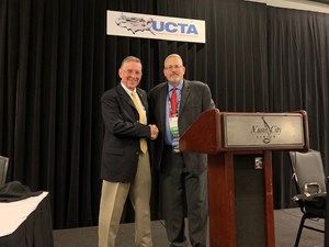 George Kurz, left, receives an award from Robert A. Carpenter, editor-in-chief of Underground Construction magazine, during the UCT conference July 14.