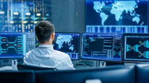 cybersecurity professional monitoring a computer for a utilities company
