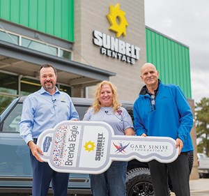 John Washburn, executive vice president at Sunbelt Rentals and Craig Cannon, national account manager with Ford, present Brenda Eagle with the key to her 2021 fully loaded, first-edition Ford Bronco.